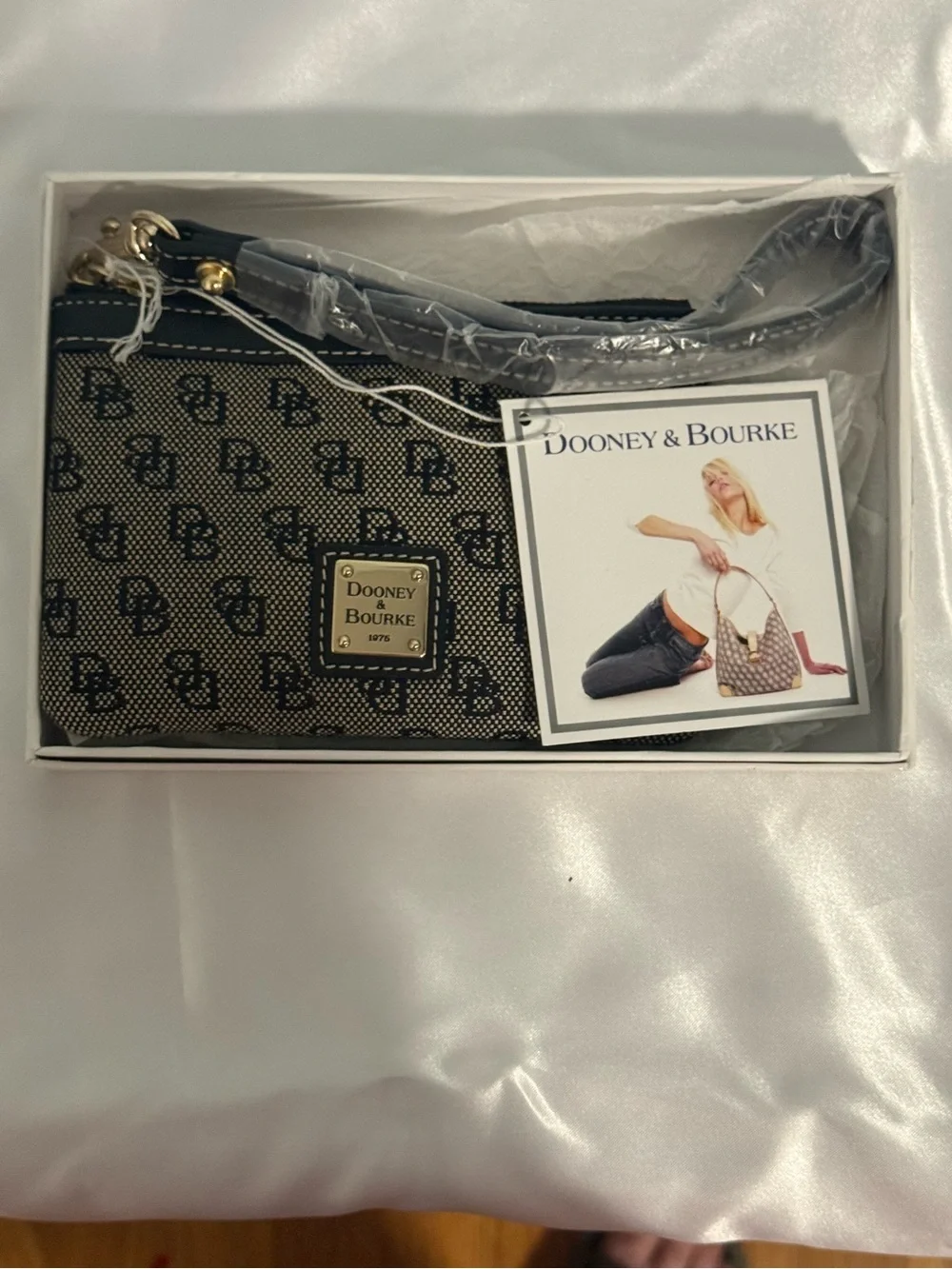 Dooney and Bourke NWT Medium logo wristlet. Comes in a box!
